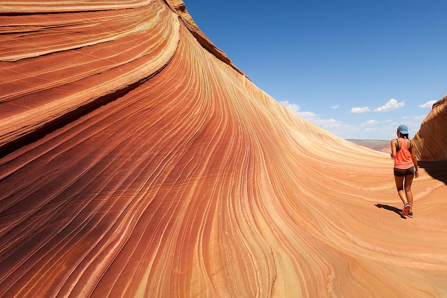 Woman hiking in The Wave sandstone formation