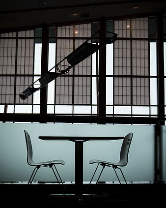 Silhouette of modern table and chairs in office interior