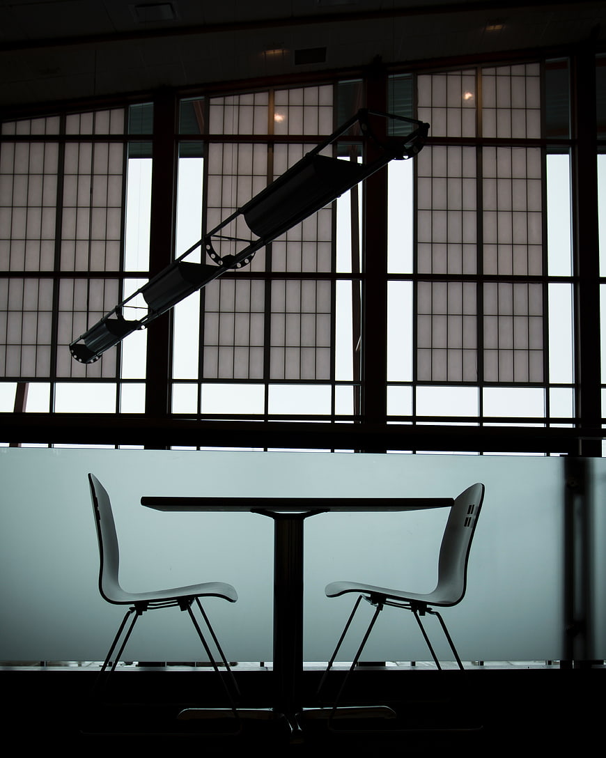 Silhouette of modern table and chairs in office interior