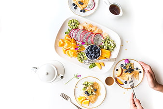Overhead View of Fresh Fruit Platter and Pancakes on White Table