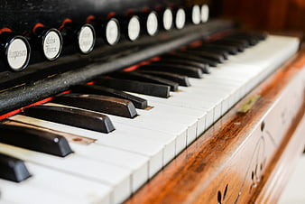 Close-up of vintage organ keys and stop knobs