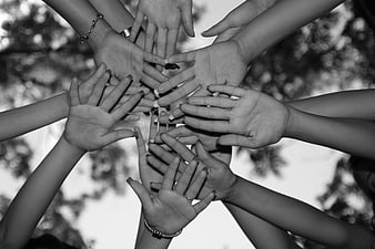Group of Hands Stacked Together in Black and White