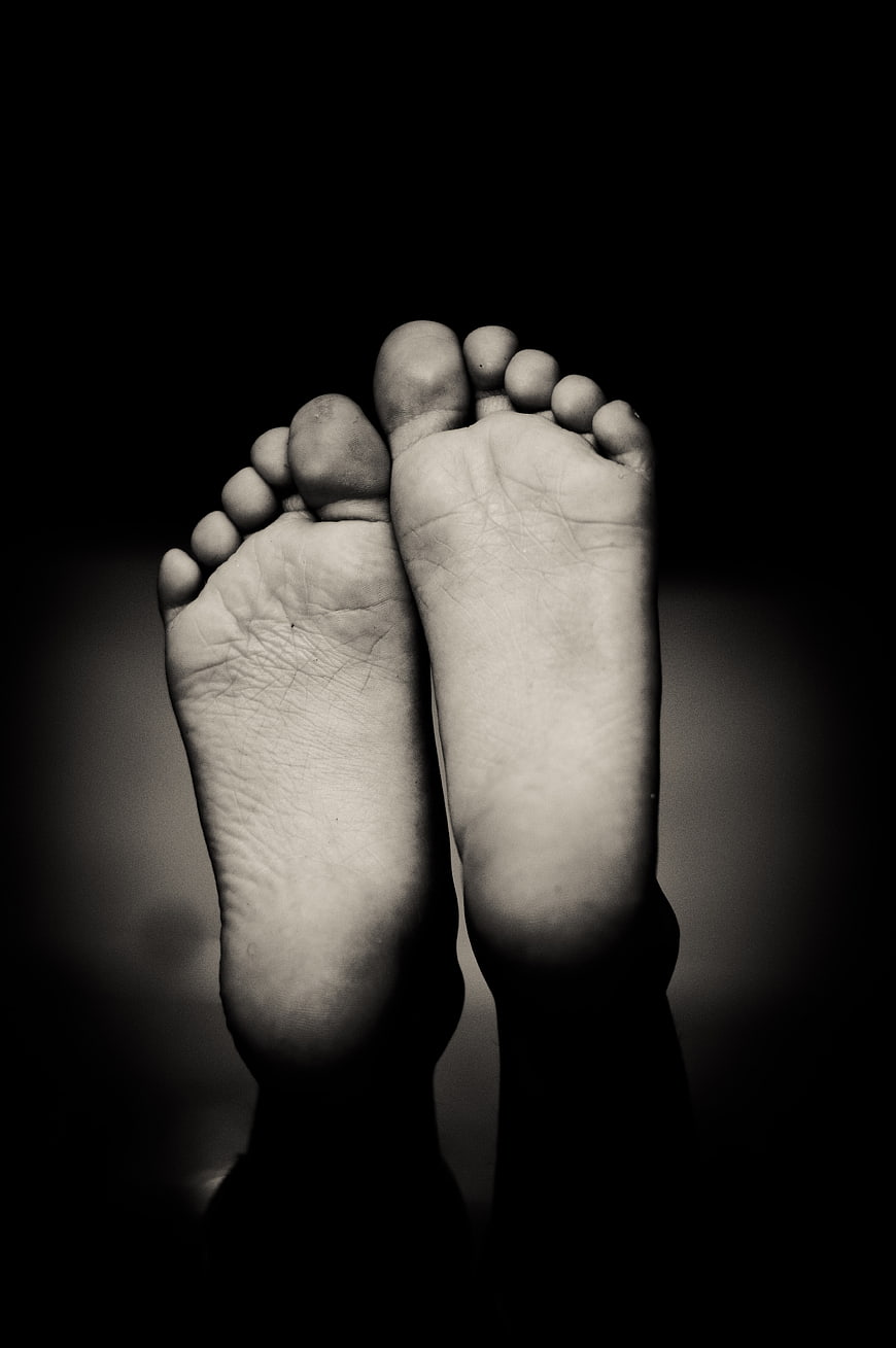 Black and white close-up of bare feet soles