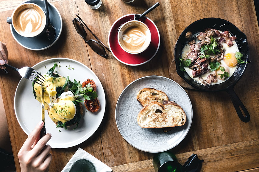 Overhead view of delicious brunch spread with eggs benedict and coffee