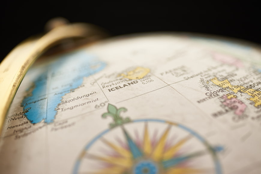 Close-up of vintage globe focusing on Iceland and compass rose