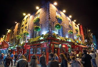 The Temple Bar pub in Dublin at night with festive lights