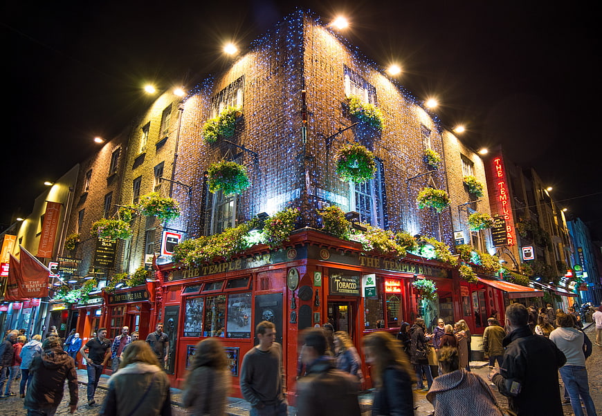 The Temple Bar pub in Dublin at night with festive lights