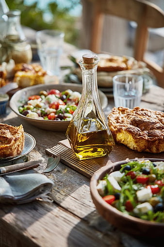 Rustic Wooden Table with Fresh Salad, Bread, and Olive Oil