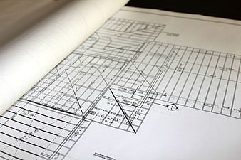 Close-up of architectural blueprints and rolled plans