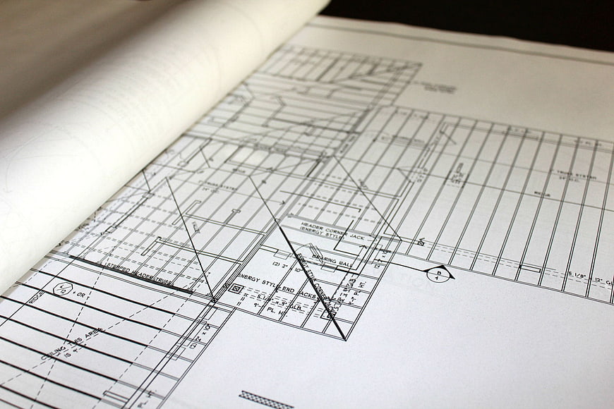 Close-up of architectural blueprints and rolled plans