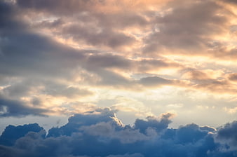 Dramatic sunset clouds with golden light breaking through
