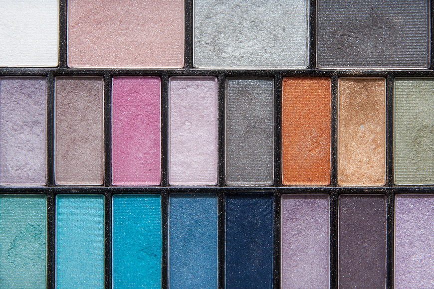 Close-up of multicolored eyeshadow palette with shimmering textures