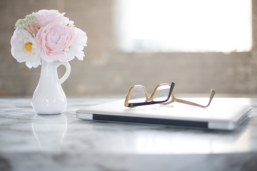 Pink Peonies in White Vase on Marble Desk with Laptop