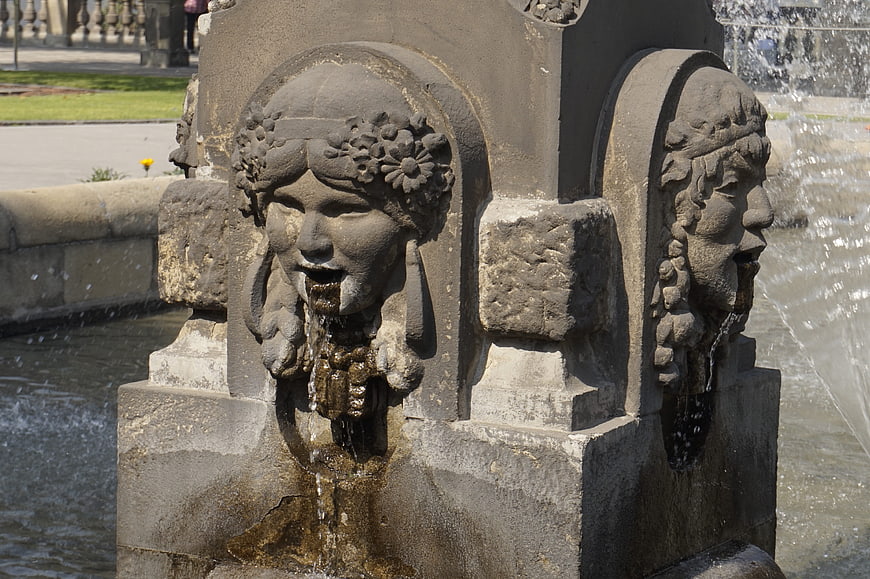 Close-up of stone fountain heads with flowing water