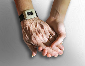 Senior and young hands holding with medical monitor