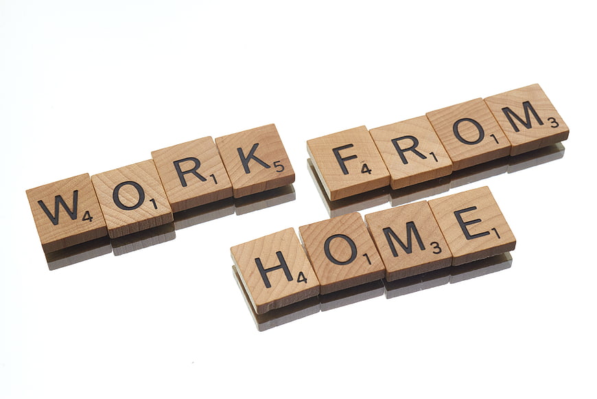 Wooden Scrabble Tiles Spelling Work From Home on White Background