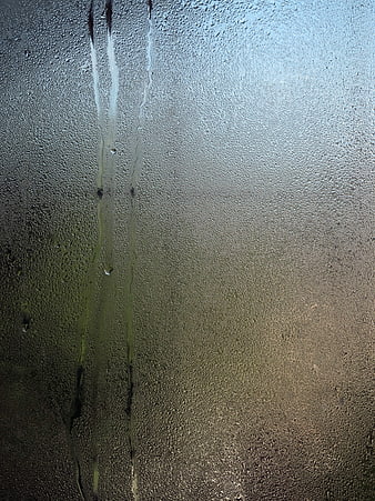 Raindrops on Glass Window with Blurred Background