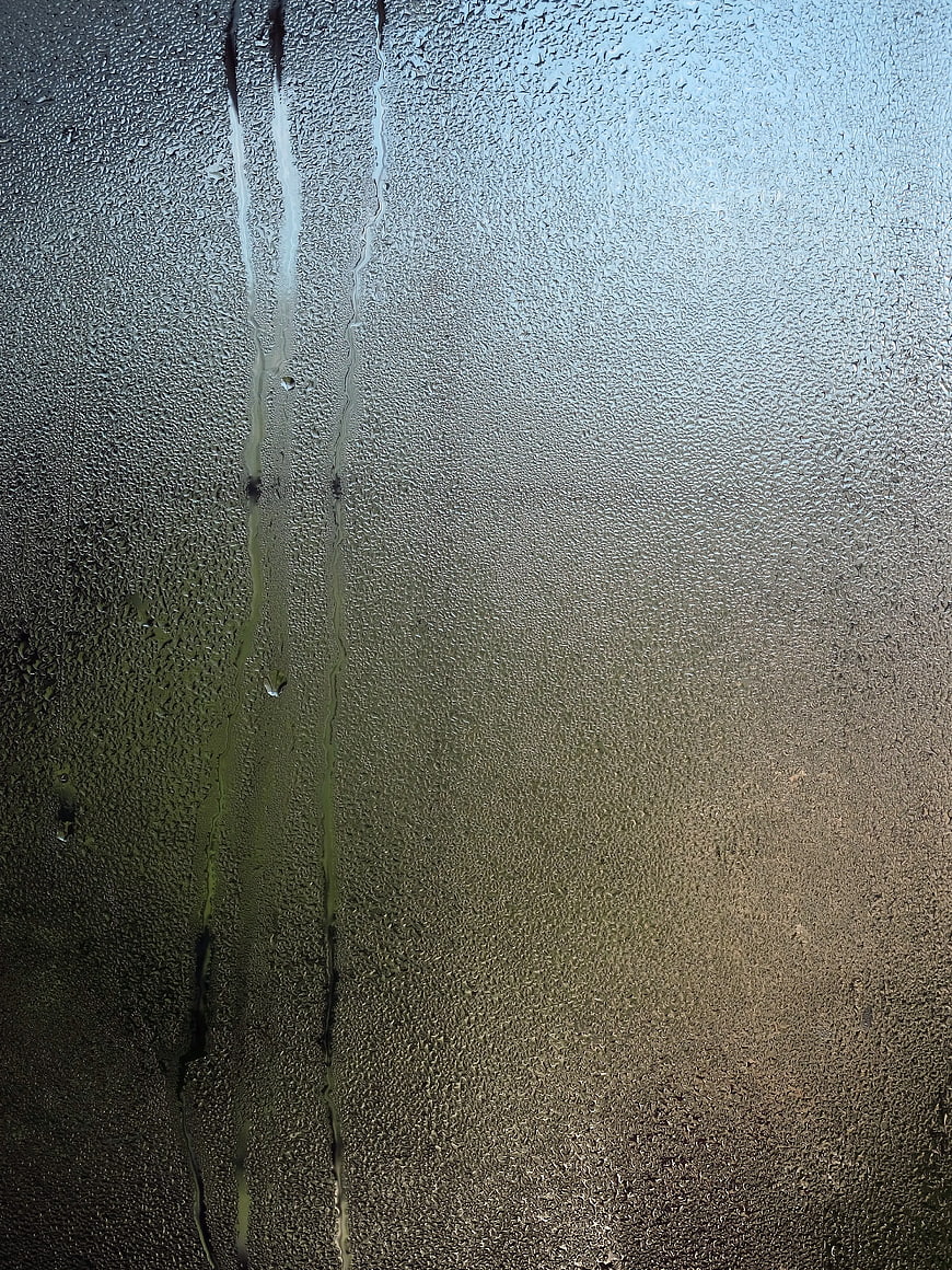 Raindrops on Glass Window with Blurred Background