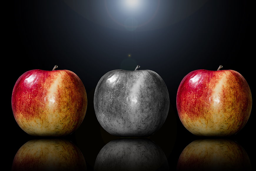 Three Apples With Central Grayscale Apple On Black Background