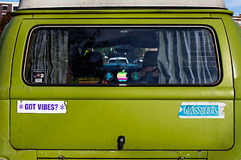 Rear view of vintage lime green van with stickers