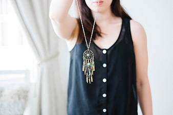 Woman Holding Dreamcatcher Necklace Close Up