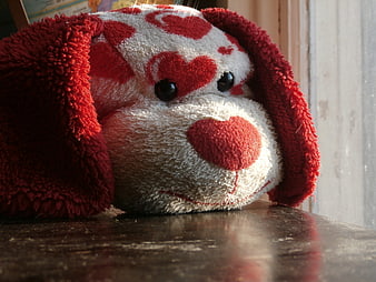 Close-up of Red and White Heart Pattern Stuffed Dog Toy