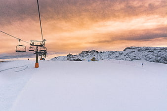 Ski Lift on Snowy Mountain Slope at Sunset