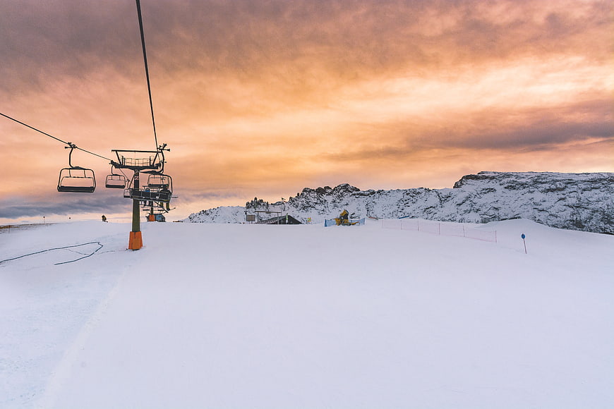 Ski Lift on Snowy Mountain Slope at Sunset