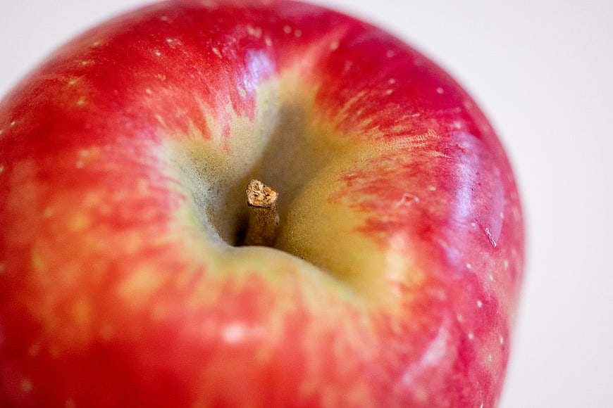 Close-up of a fresh red apple with stem