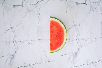 Minimalist Watermelon Slice on White Marble Background