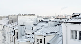 White urban rooftops with metal details and city skyline