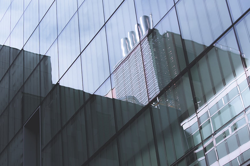 Modern Glass Building Facade with City Reflection