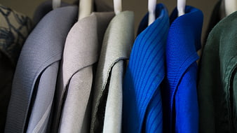 Close-up of colorful shirt collars hanging on a rack
