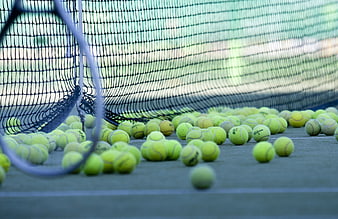 Scattered Tennis Balls On Court With Racket And Net