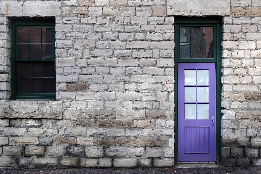 Purple Door on Old Stone Building Facade