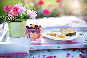 Breakfast in Bed with Fried Eggs, Toast, Fruit, and Flowers