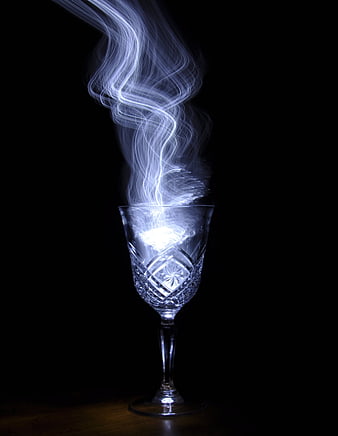 Crystal Wine Glass With Glowing White Smoke On Black Background