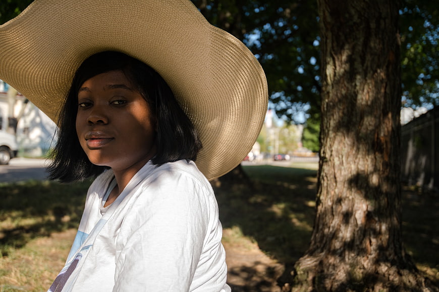 Portrait of Woman in Wide Brim Straw Hat Outdoors