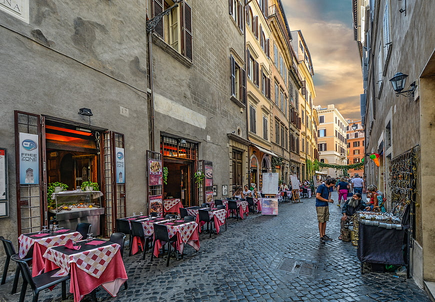 Cobblestone Street in Rome with Outdoor Restaurant Tables