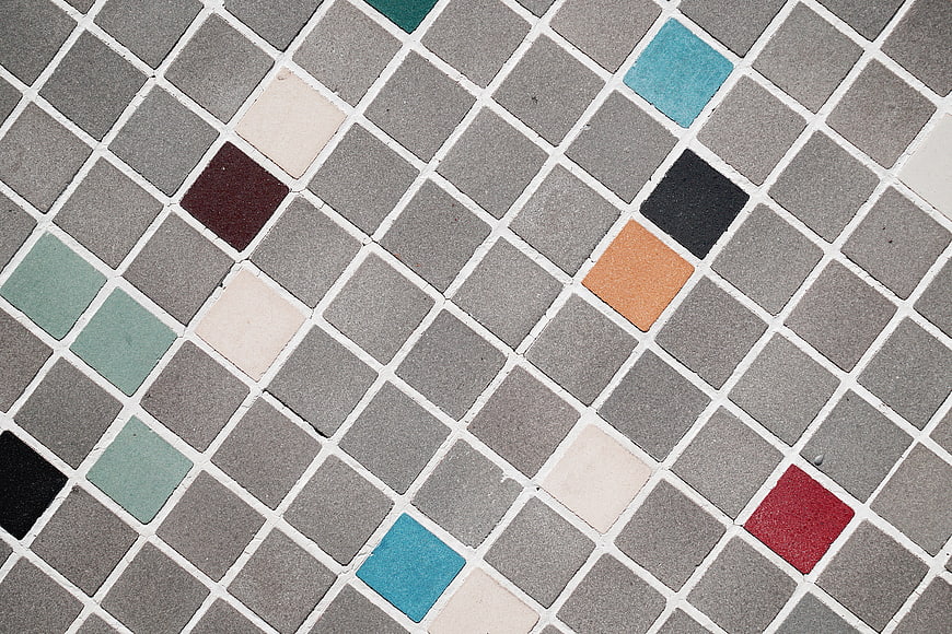Gray mosaic tile pattern with colorful accents