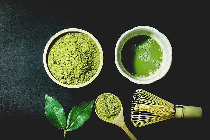 Top View Matcha Tea Powder, Whisk, and Bowl on Dark Background