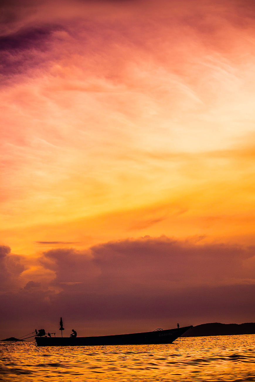 Silhouette of Fishing Boat on Golden Sunset Sea