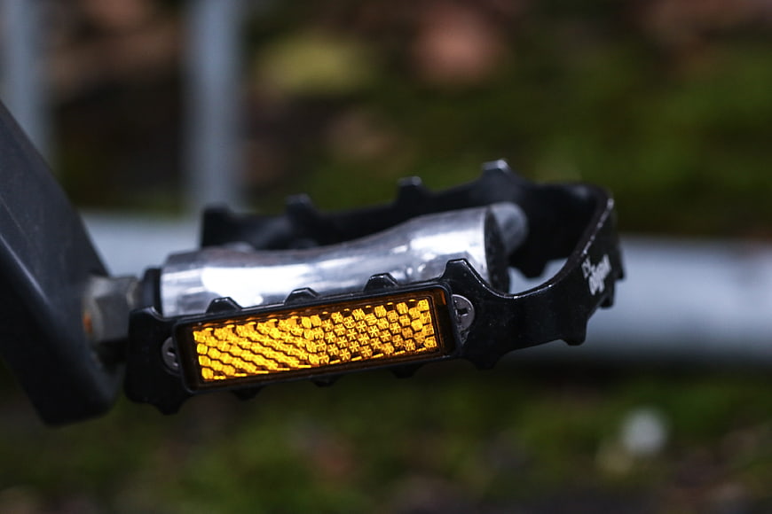 Close-up of bicycle pedal with yellow reflector