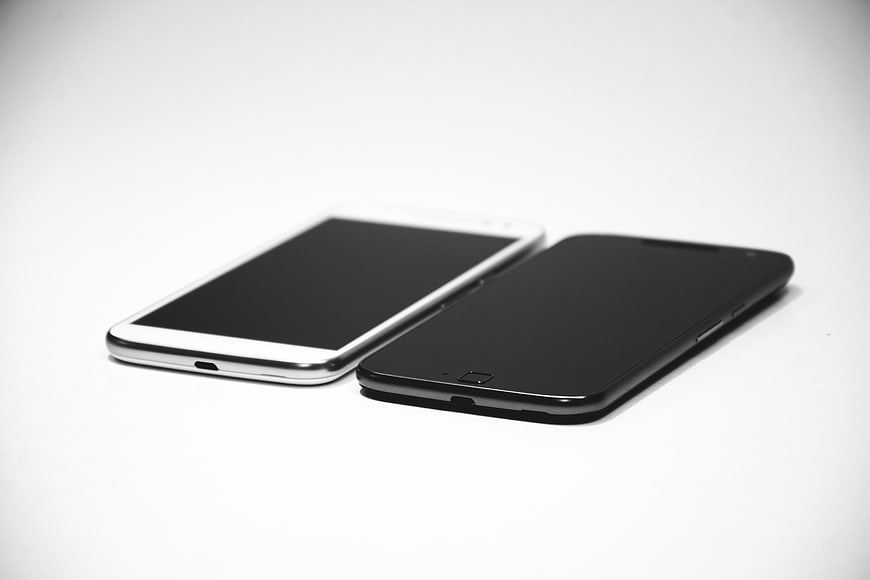 Two smartphones on white background