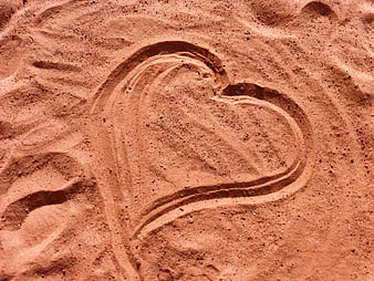 Heart drawn in sand on a beach