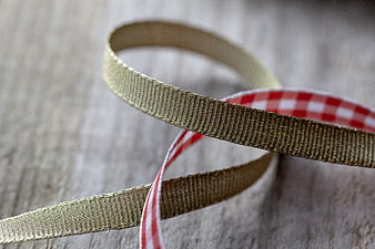Gold and Red Gingham Ribbon on Wooden Background
