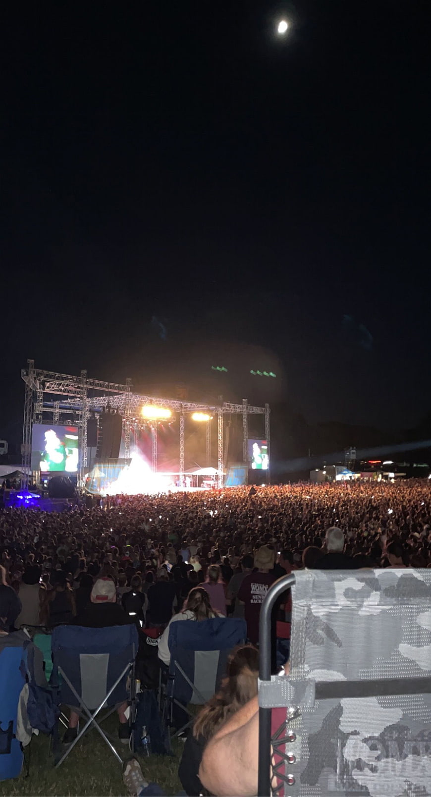 Nighttime outdoor music festival crowd and stage