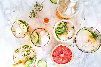 Overhead view of refreshing cucumber and grapefruit cocktails on ice