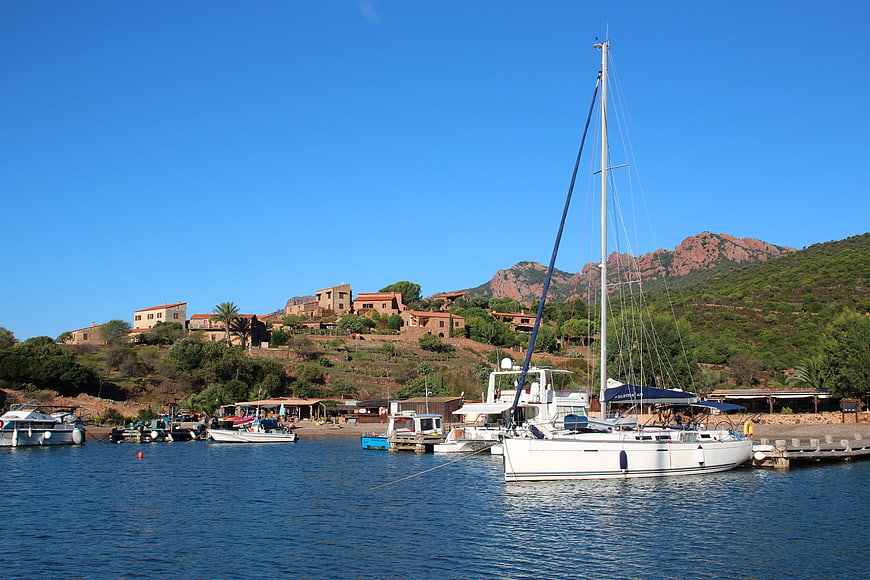 Sailboat in Mediterranean Harbor with Hillside Village