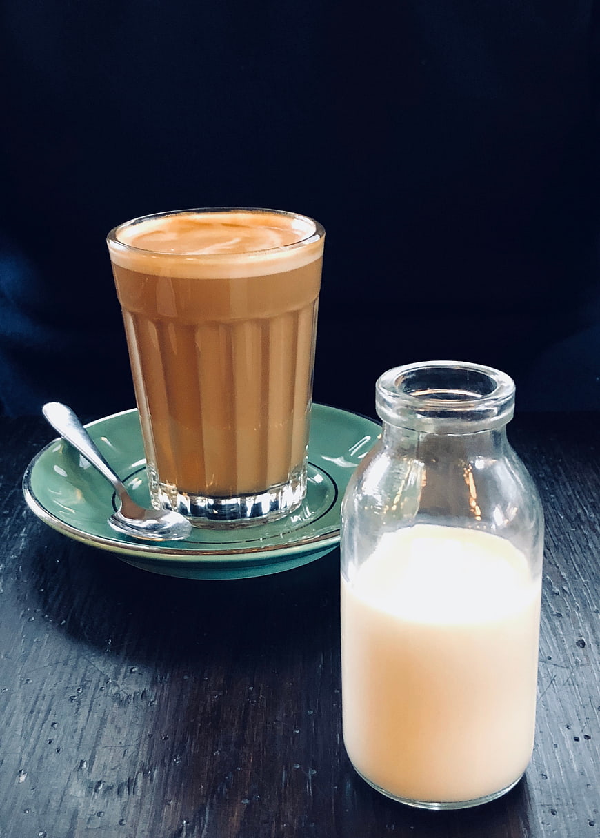 Iced Latte and Milk Bottle on Dark Table